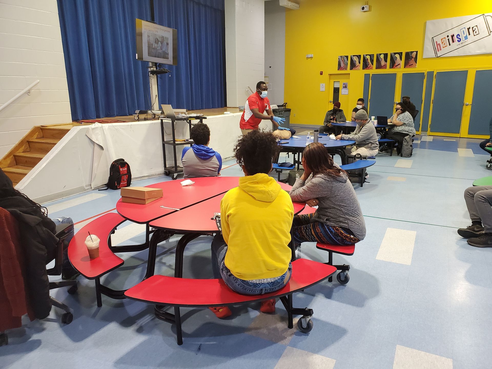A group of people are sitting at tables in a room.