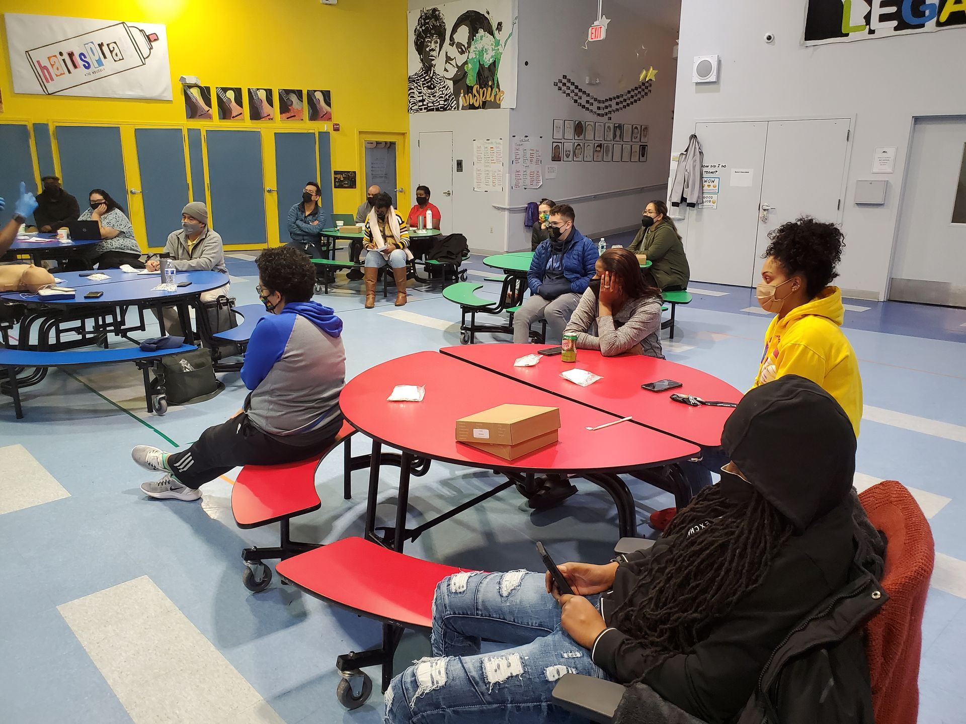 A group of people are sitting at tables in a room.