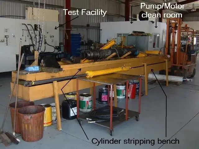 Interior of a Repair Shop With a Cylinder Stripping Bench and a Forklift — Alloway Hydraulics in Mount Saint John, QLD