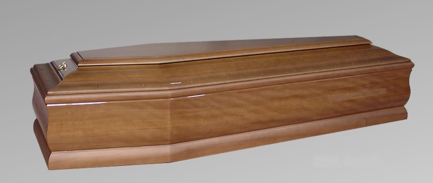 Una bara di legno è appoggiata su una superficie grigia.