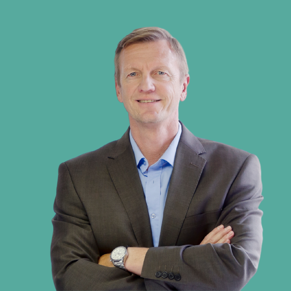 A man in a suit with his arms crossed and a watch on his wrist
