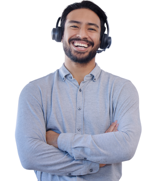A man wearing headphones is smiling with his arms crossed