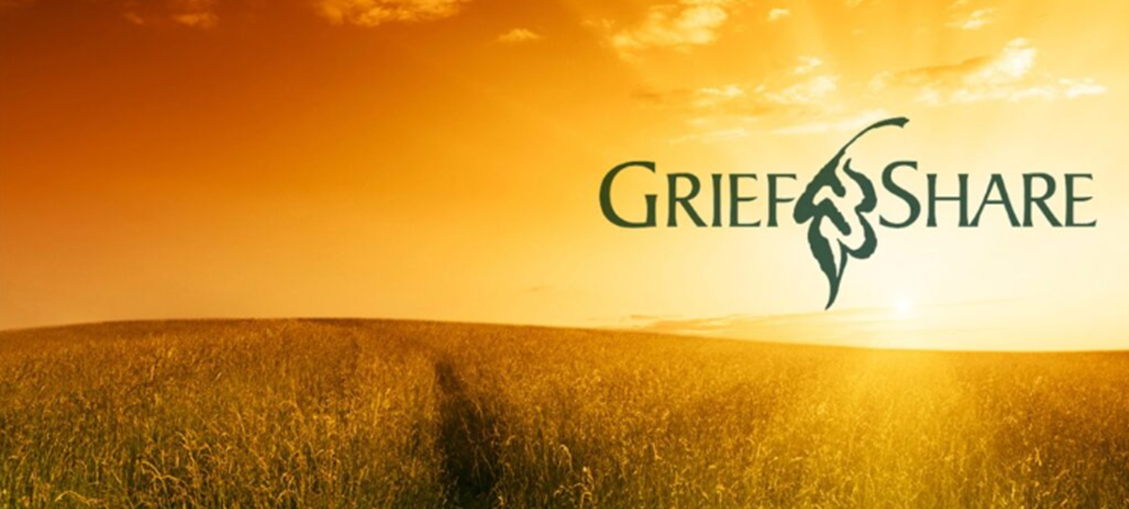 Logo for GriefShare against a sunset over a field of tall grass.