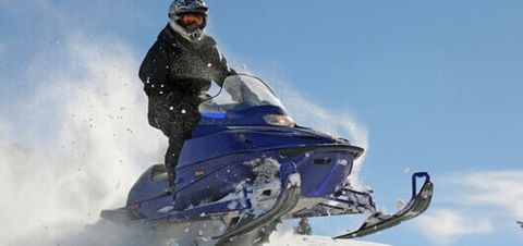 Man in snowbile ski — Auto Body Services in Oneida, NY