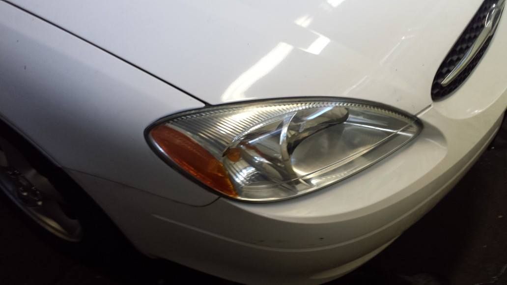 A close up of a white car 's headlight