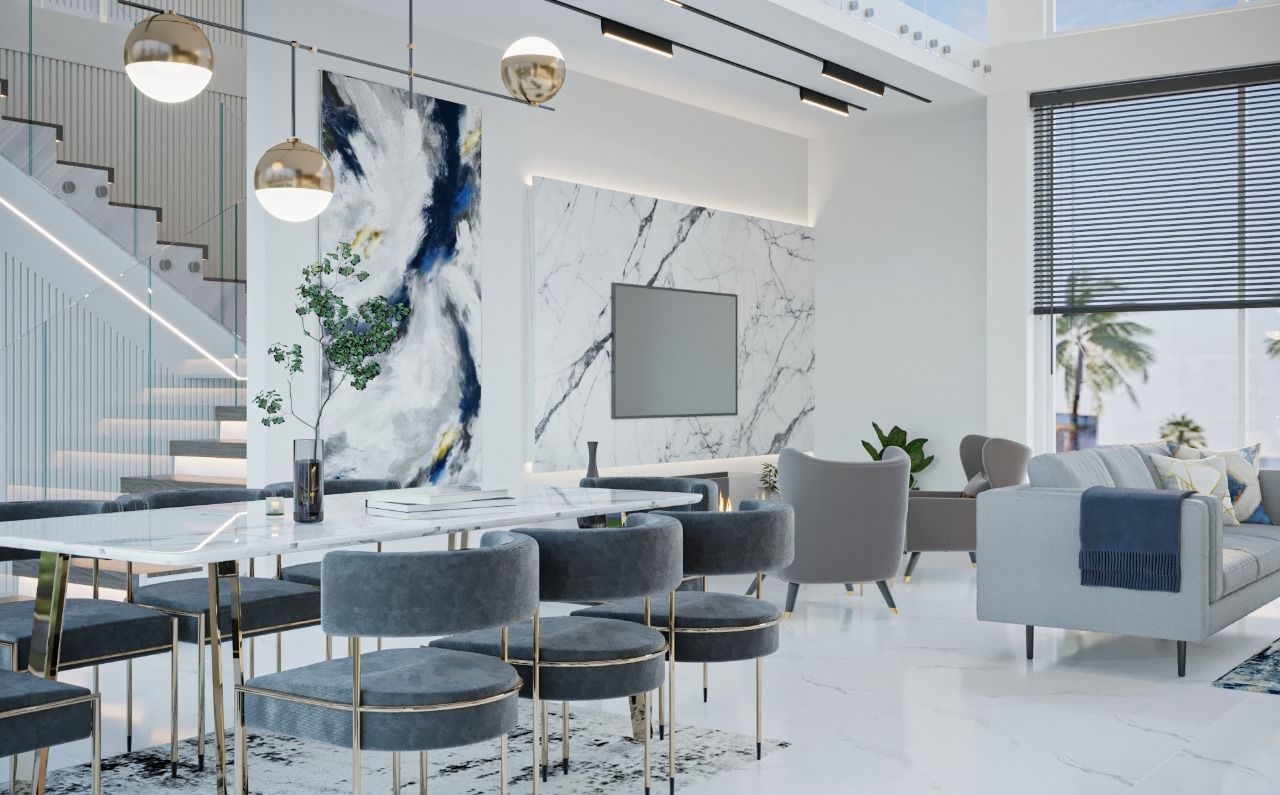 Luxurious modern dining area with marble accents, gray furniture, and gold light fixtures.