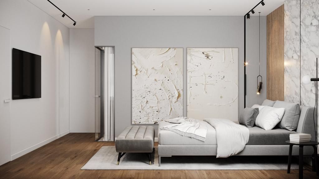 Modern bedroom with gray walls, wood floor, bed, abstract art, and TV.