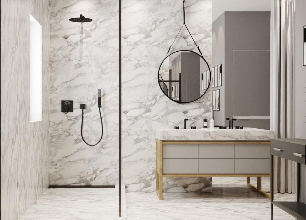 Modern marble bathroom with shower, vanity, and mirror, featuring black fixtures and a neutral color palette.