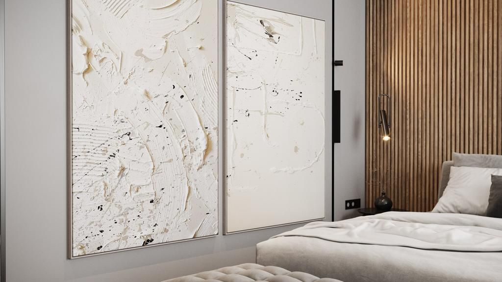 Two white textured abstract art panels hang on a gray wall above a bed with wood paneling.