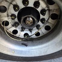 A close up of a truck wheel with a hose coming out of it.