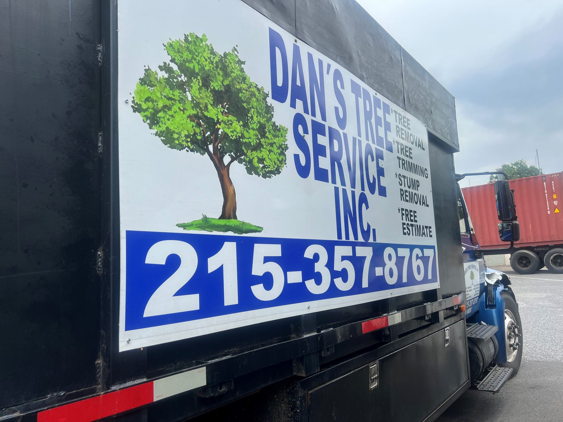 A truck with a sign on the side that says dan 's tree service inc.