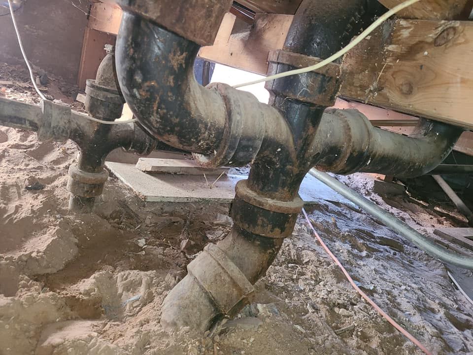 A bunch of pipes are connected to each other in a basement.