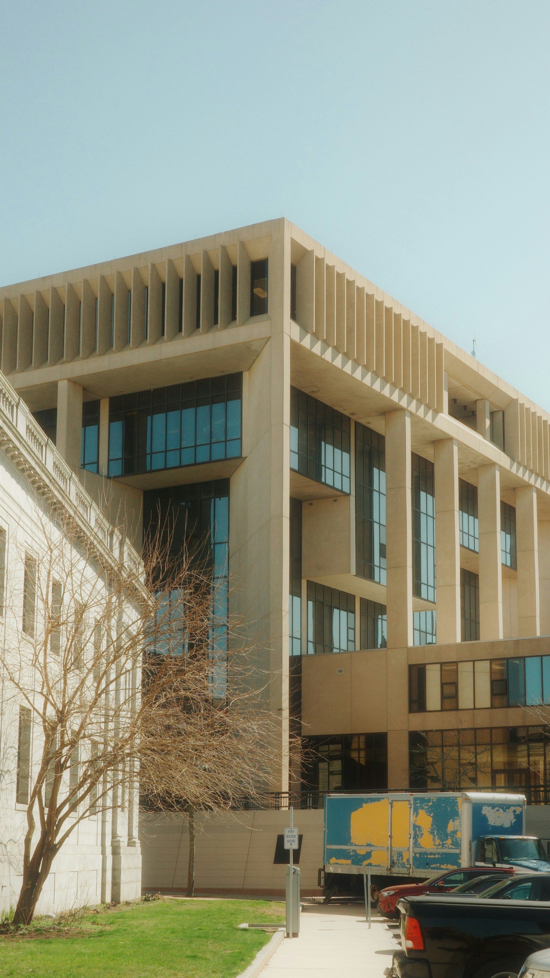 A large building with a blue truck parked in front of it