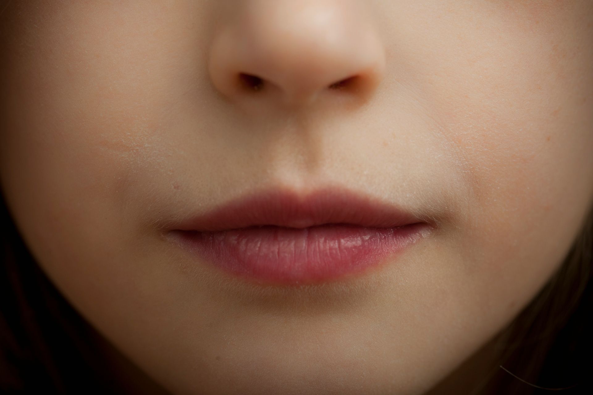 A close up of a woman 's lips and nose.