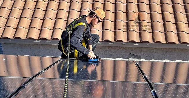 Worker installing wire mesh barriers for bird protection