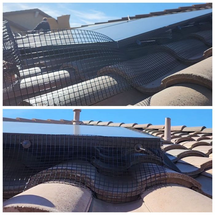 Picture of solar panel pigeon guard securely fastened around a solar panel corner with clips.