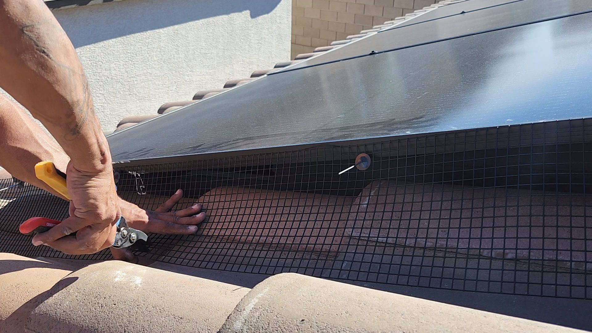 Bird mesh being applied to solar panel