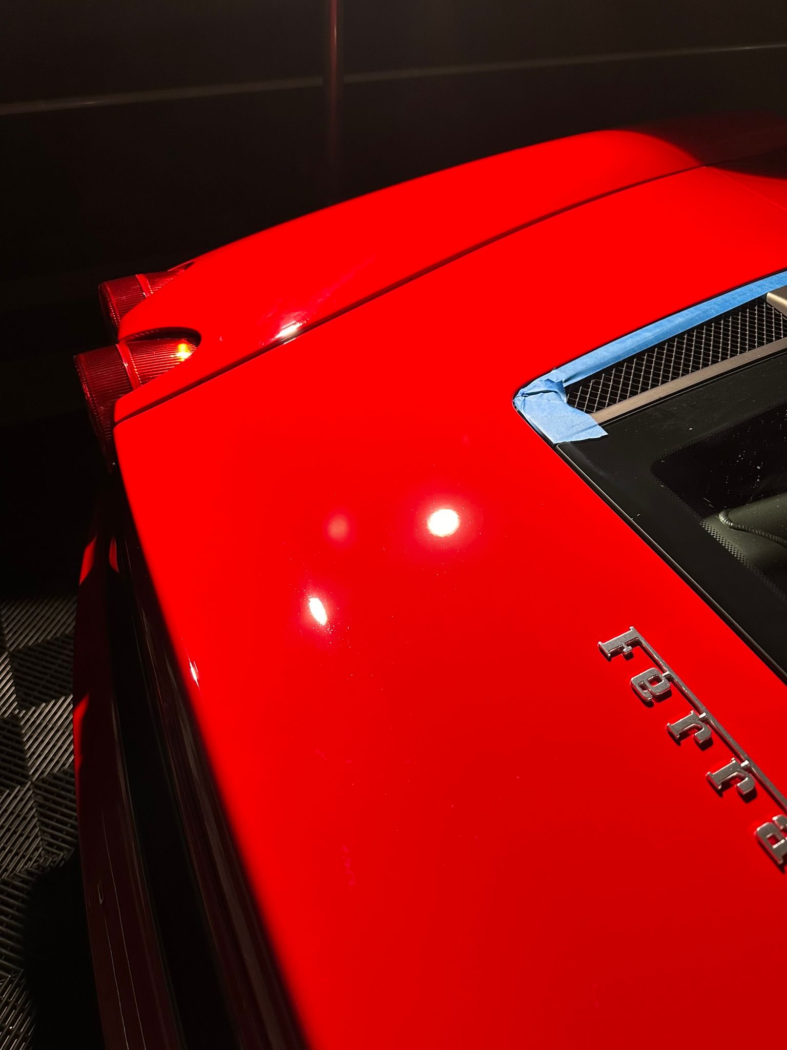 A red car with the word ferrari on the hood