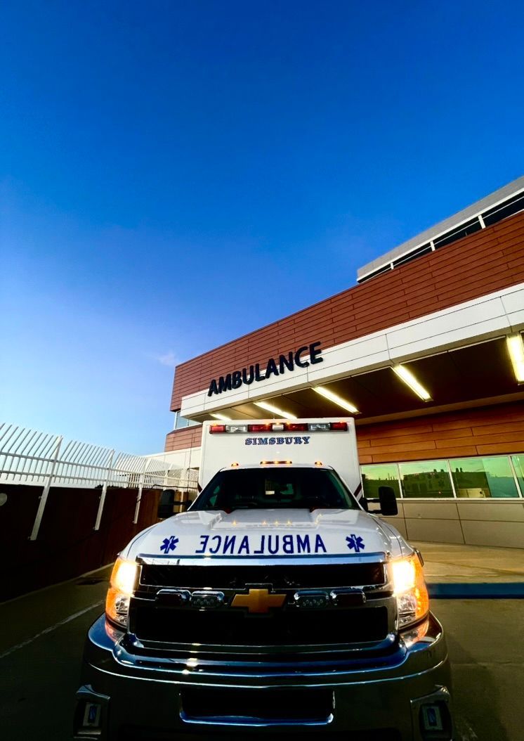 A Simsbury ambulance is parked in front of UConn John Dempsey Emergency Department Ambulance Entrance.