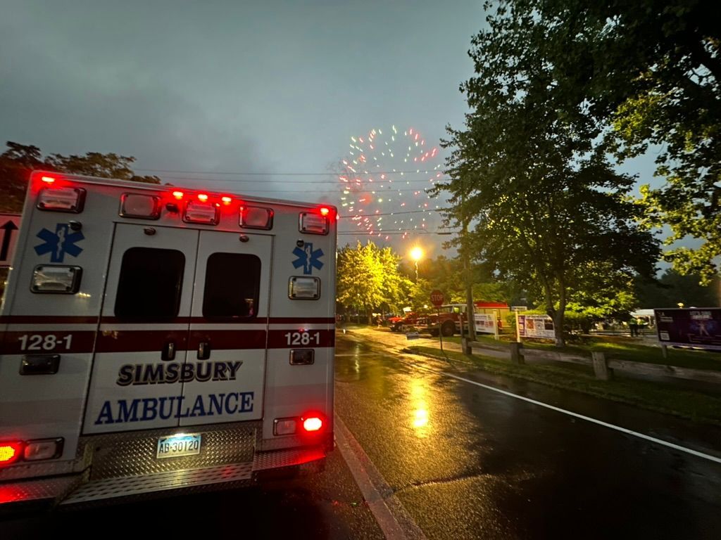 A Simsbury ambulance is parked on the side of the road during the Talcott Mountain Music Festival Fireworks.
