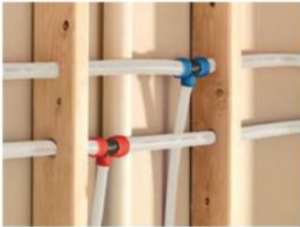 A bunch of pipes are attached to a wooden wall