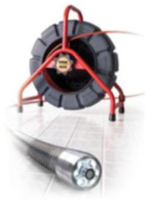 A drain camera is sitting next to a tire on a tiled floor