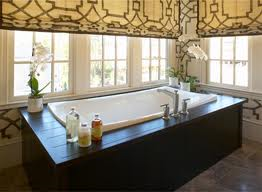 A bathroom with a large tub and a lot of windows