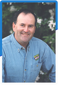 A man wearing a blue shirt with a badge on the left pocket