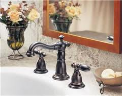 A bathroom sink with a mirror and a vase of flowers.