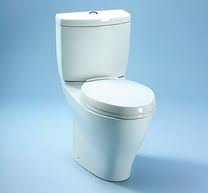 A white toilet is sitting on a blue surface.