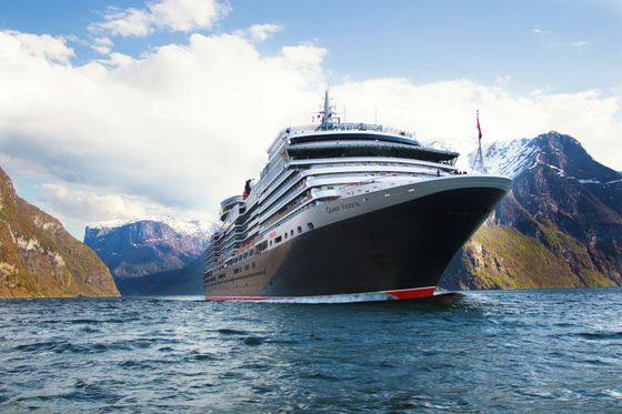 A large cruise ship is floating on top of a body of water.