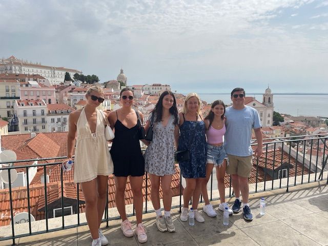 Tin Fish Travel's family posing for a picture overlooking Lisbon.