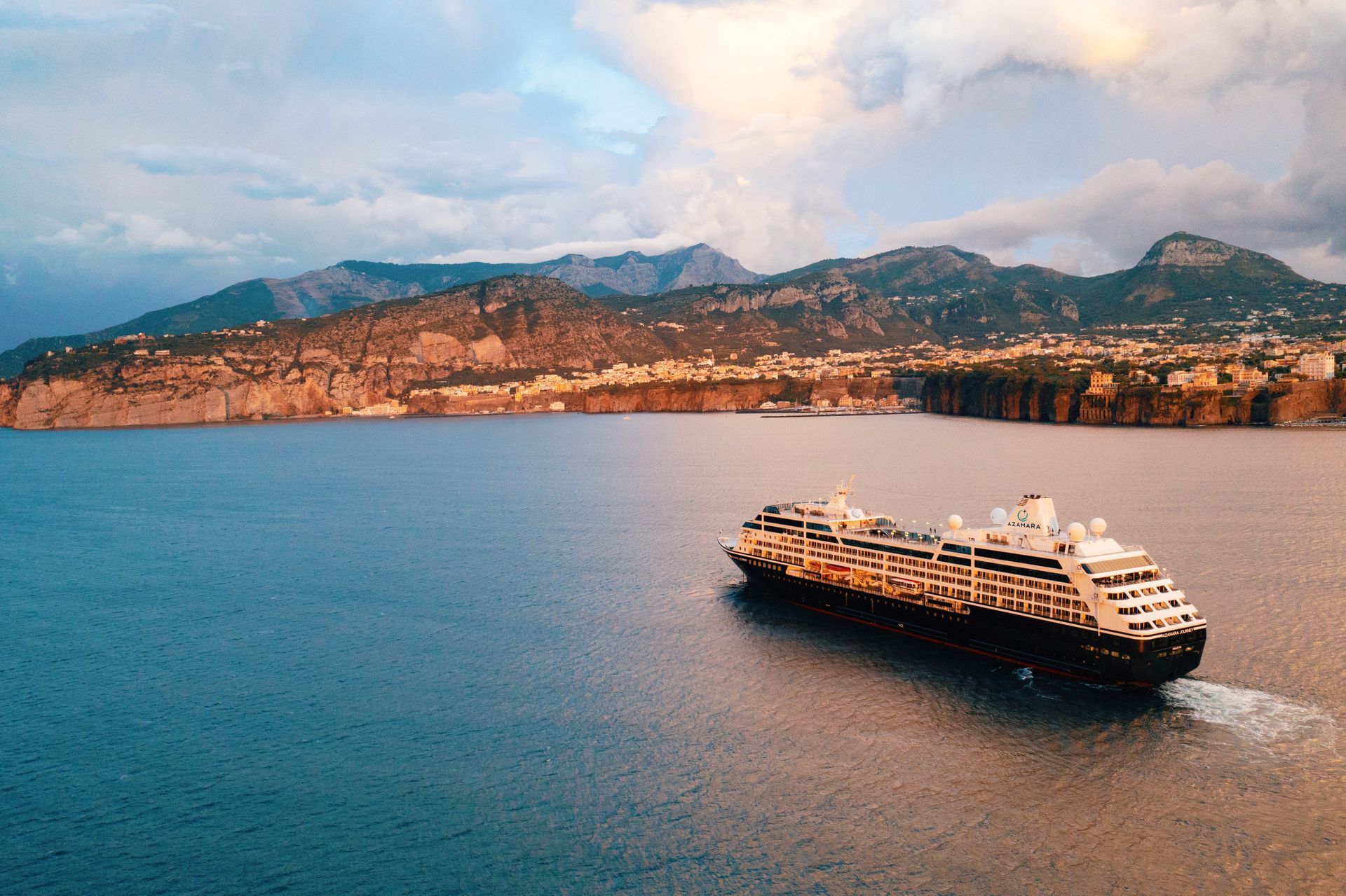 A large cruise ship is floating on top of a large body of water.