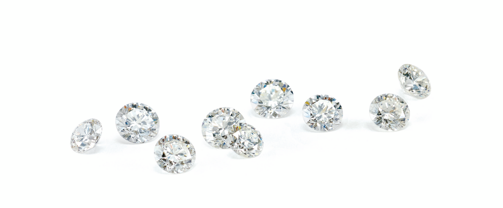 a group of diamonds are lined up in a row on a white background 