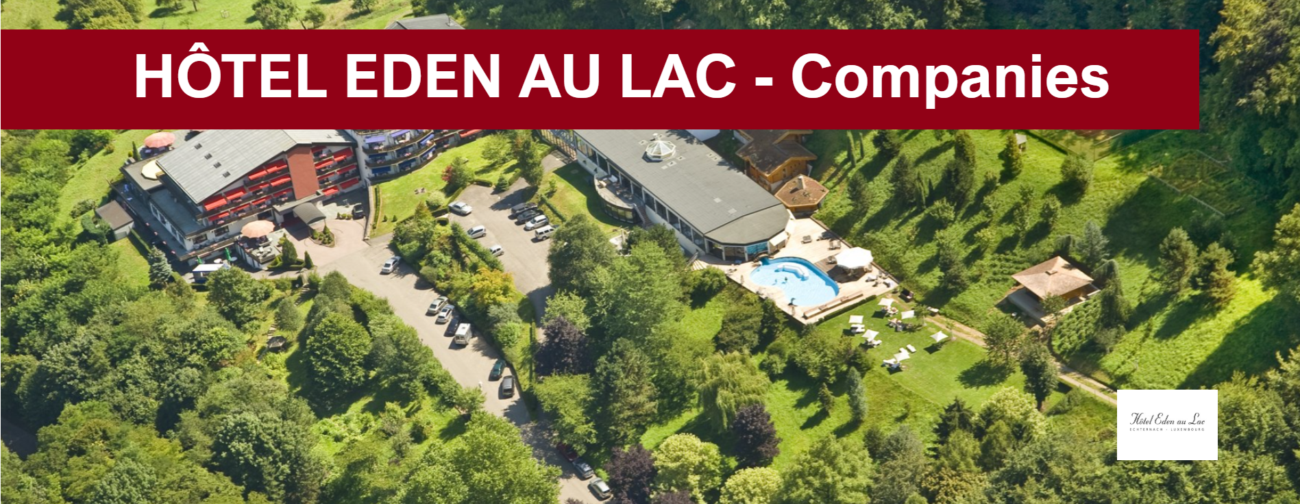 Vue aérienne de l'Hôtel Eden au Lac niché dans la verdure, avec vue sur la piscine et le lac.