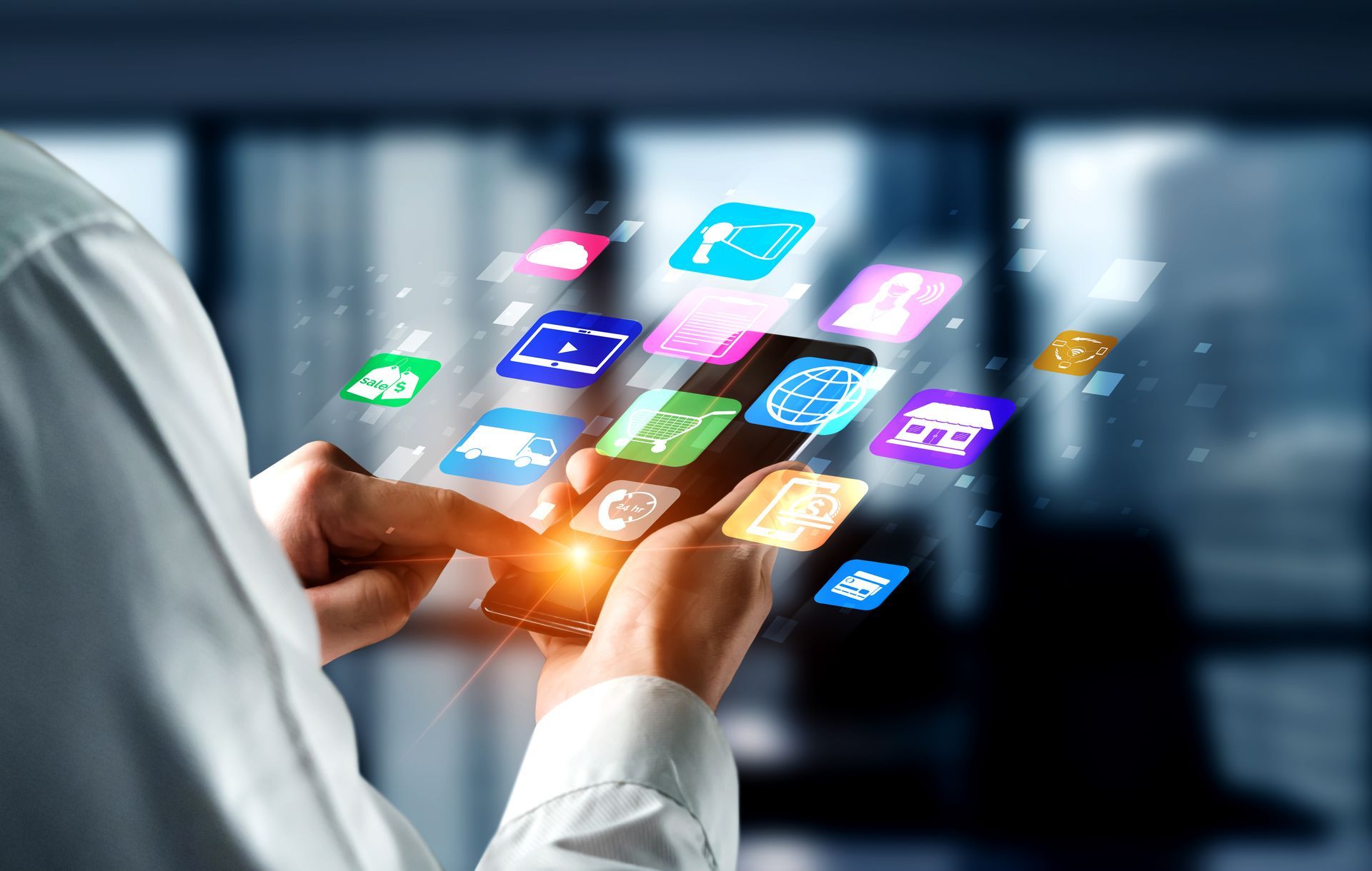 A person is holding a cell phone with a bunch of apps coming out of it.