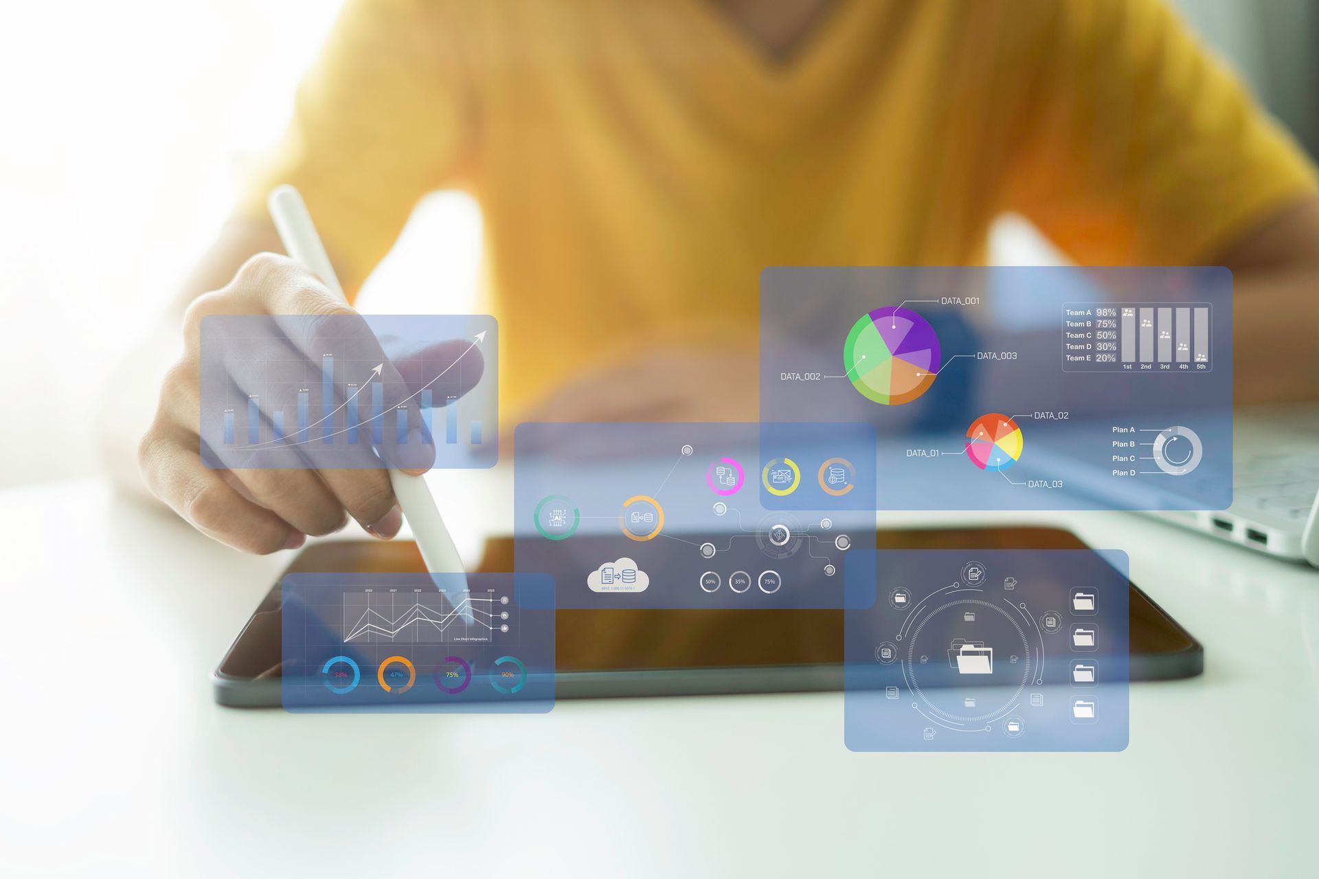 A woman is sitting at a desk using a laptop computer.