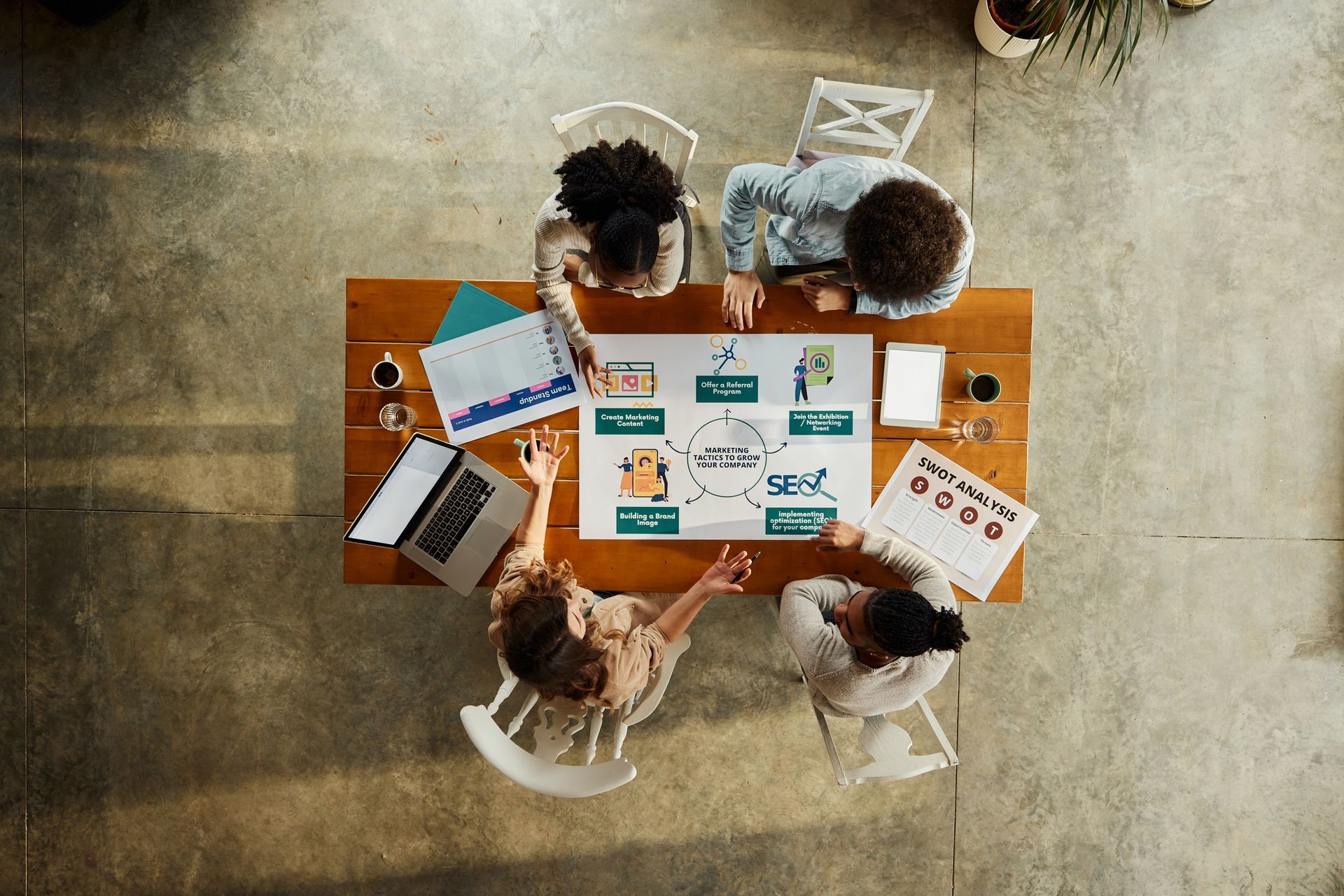 A person is typing on a laptop computer with a shopping cart on the screen.