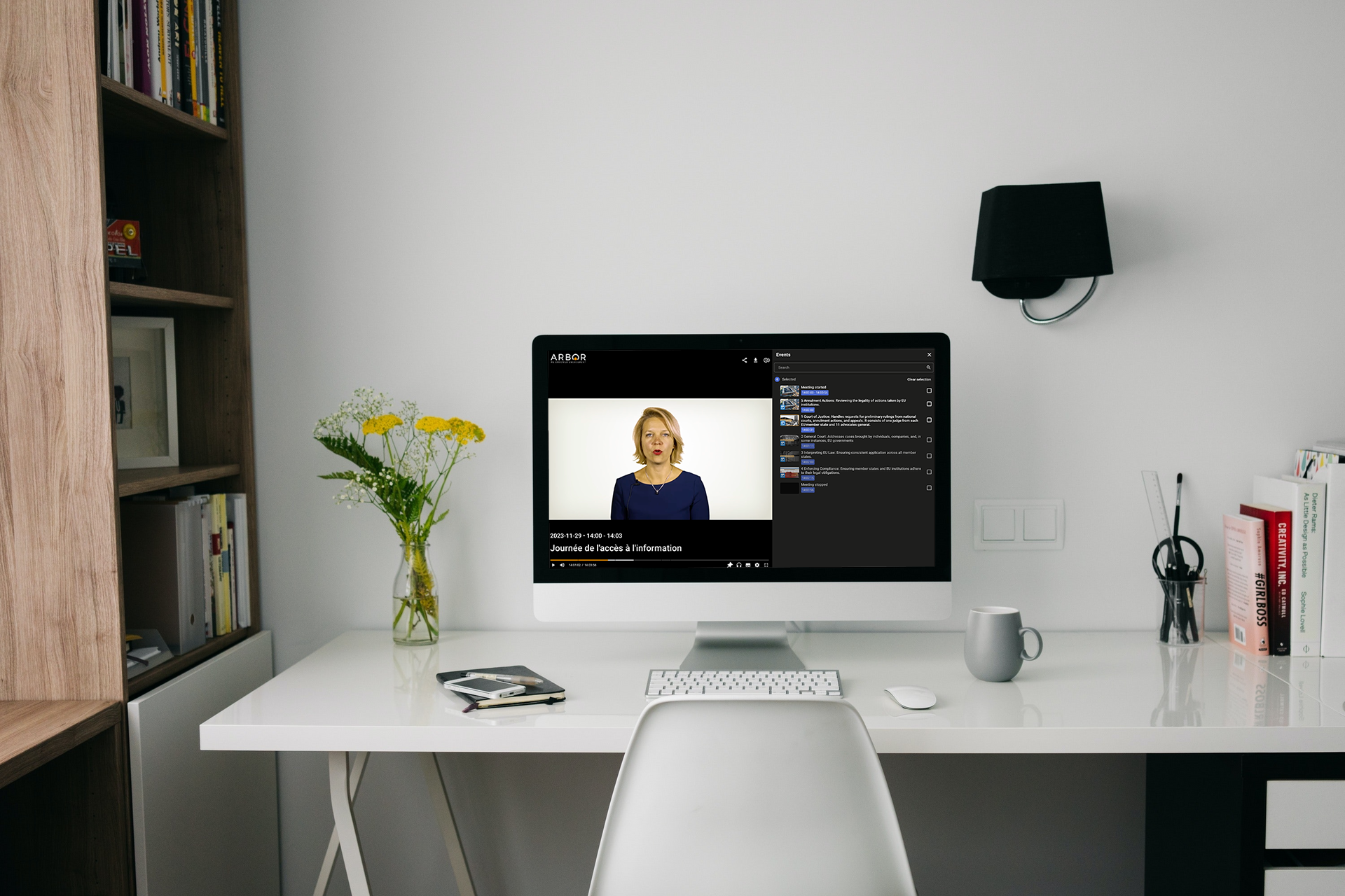 A desk with a computer monitor displaying the arbor platform