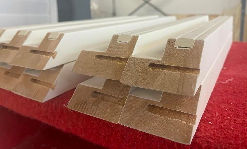 A stack of wooden pieces sitting on top of each other on a red table.