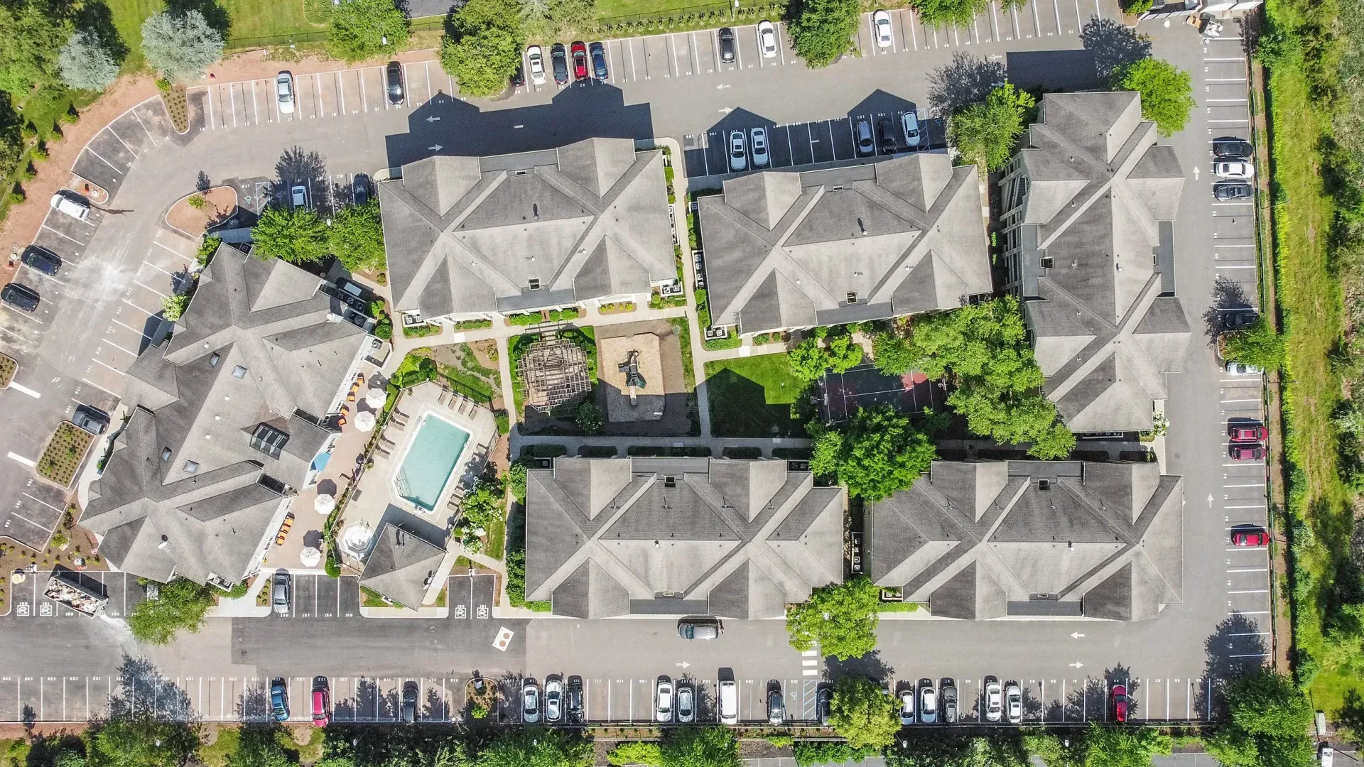 An aerial view of a residential area with a pool