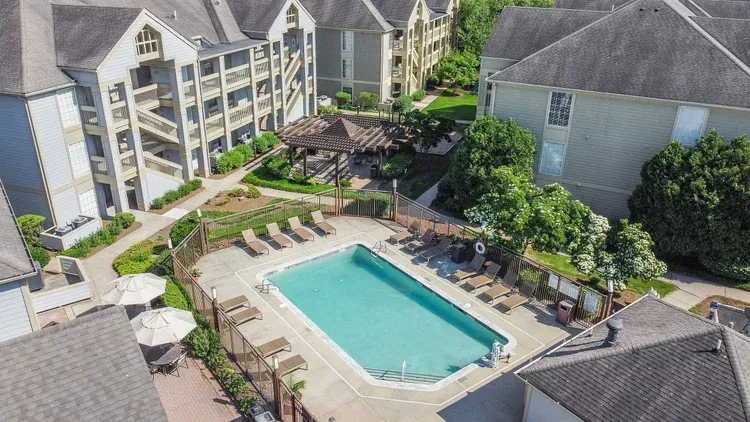 An aerial view of a large swimming pool surrounded by buildings.