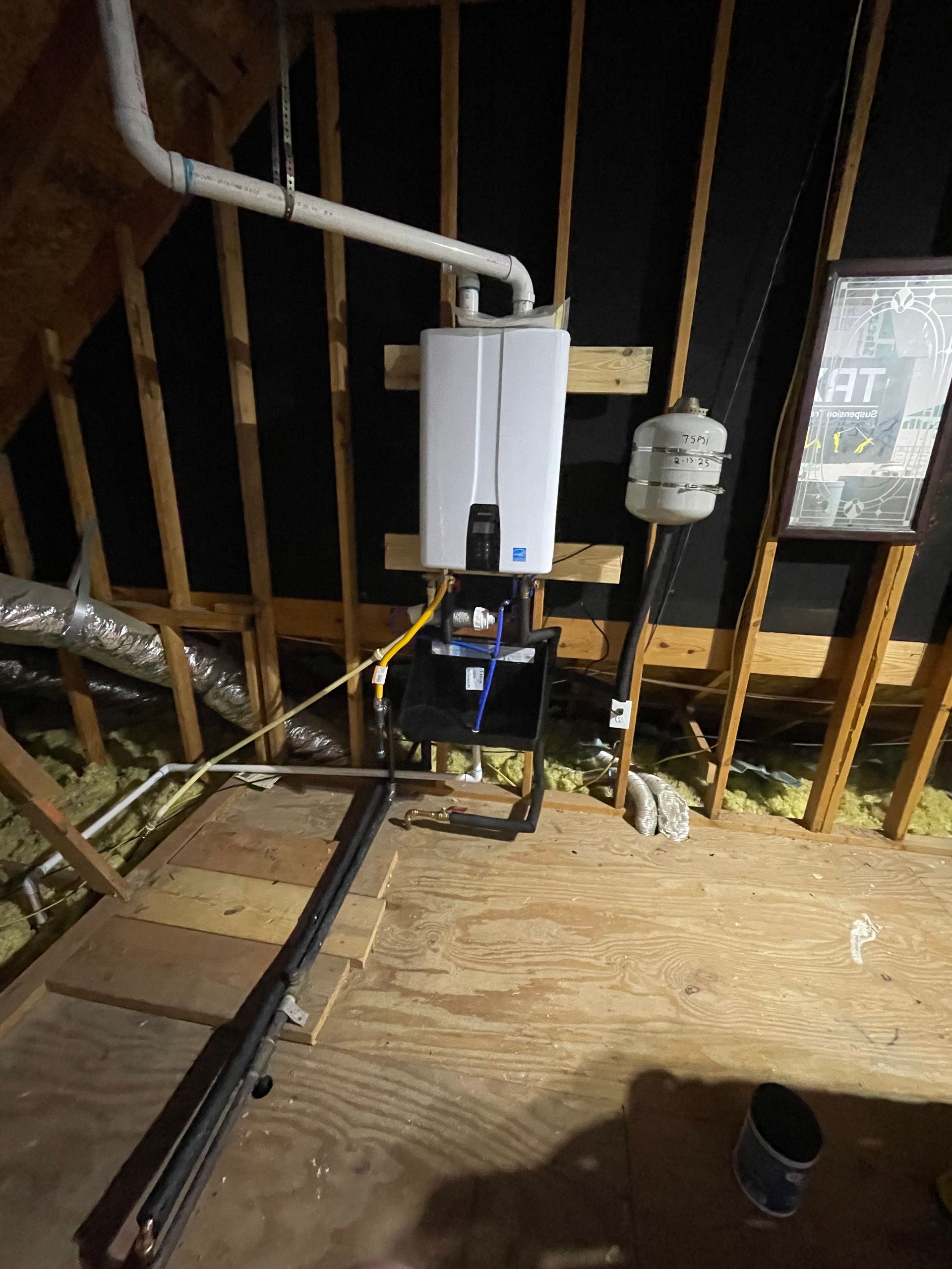 A water heater is installed in the attic of a house.