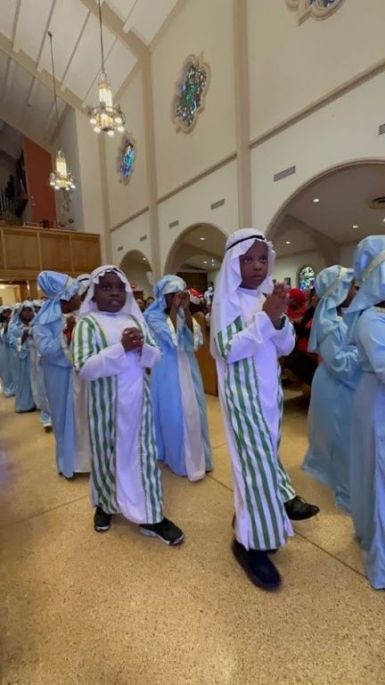 A group of people dressed in religious costumes are standing in a church.