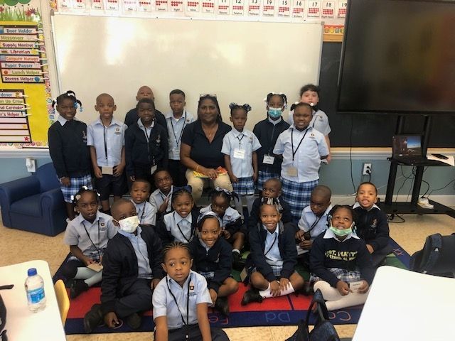 A group of children are posing for a picture in a classroom.