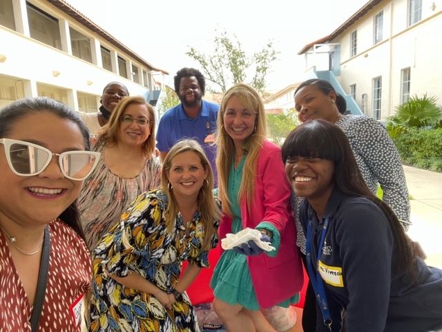 A group of people are posing for a picture in front of a building.