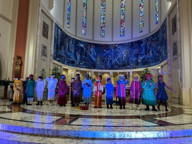 A group of people in colorful costumes are standing in a church.