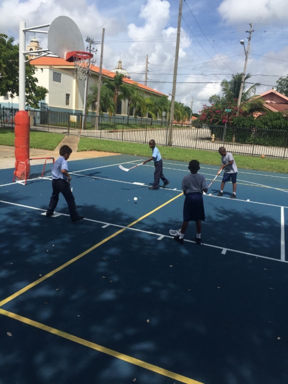 A group of children are playing basketball on a court