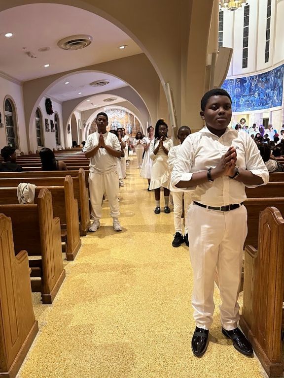 A group of people are praying in a church.
