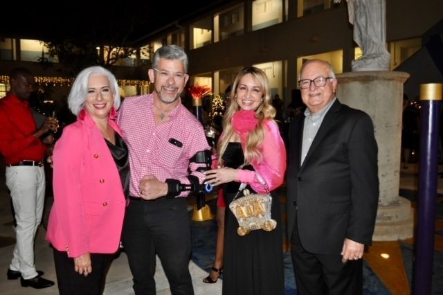 A group of people are posing for a picture in front of a building.